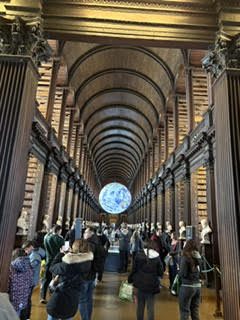 Visitors fill the Long Room library at Trinity College Dublin beneath its barrel-vaulted wooden ceiling